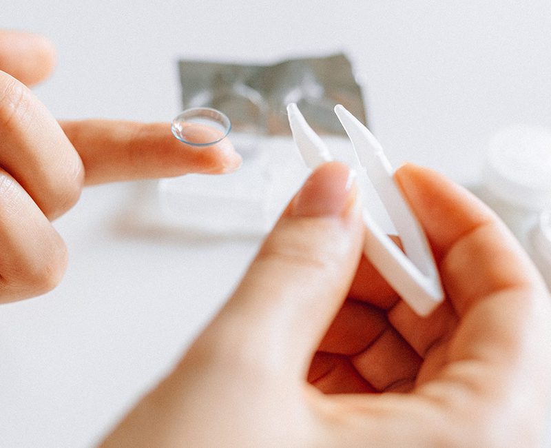an optometrist fits a contact lens