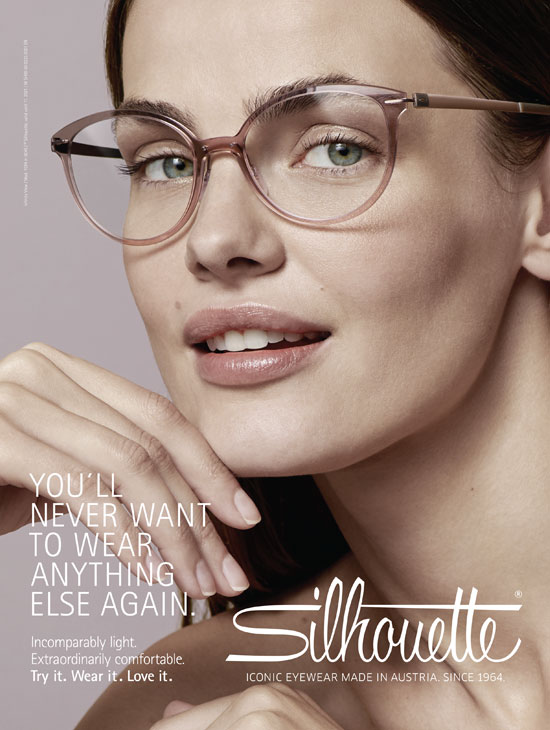 a model wears designer eyeglasses while looking into the camera